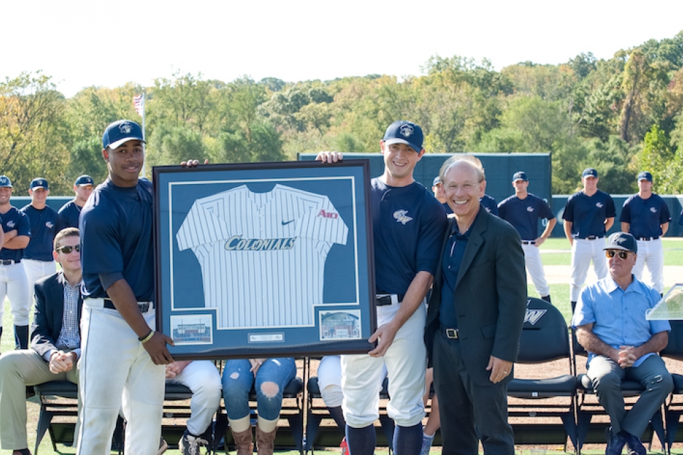 Ave Tucker with GW baseball players at the dedication of Tucker Field at Barcroft Park. (GW Today)