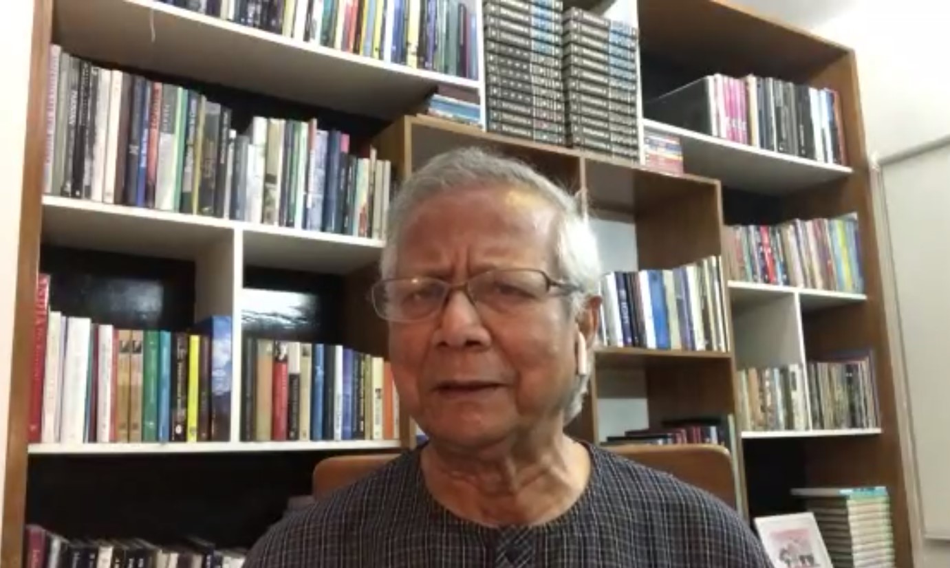 Muhammad Yunus gives virtual talk in front of a book shelf 