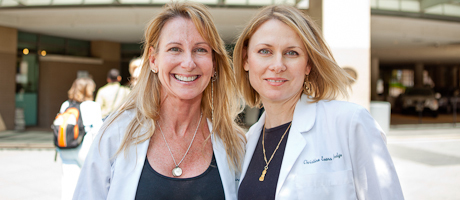 Kathryn Boling and Christine Hodge smile in lab coats