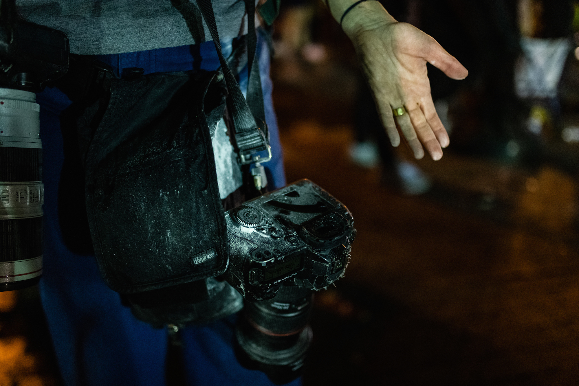 Image of a person with a camera covered in debris