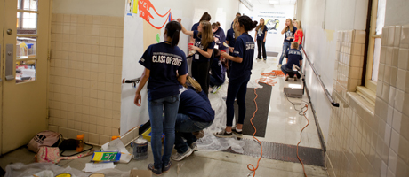 students painting a mural in a Washington, D.C. public school hallway 