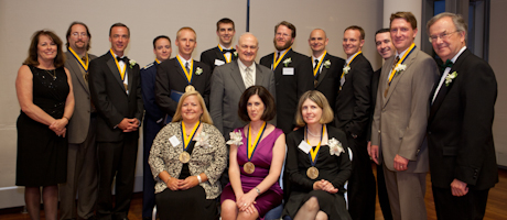Kathryn Newcomer, Steven Knapp and Peter Williams pose with the 13 Flemming Award winners