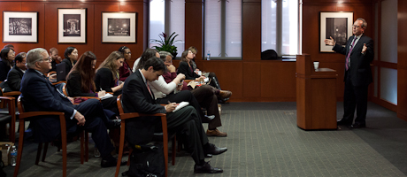 Frank La Rue speaks at podium with audience looking on 