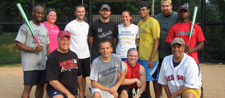 members of Zero Athletic Ability stand as a group some standing and some kneeling, some holding bats