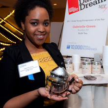 Gabrielle Green holds glass teapot smiling