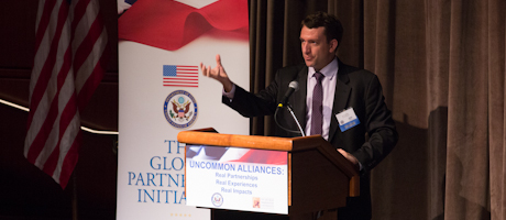 Joe Carson speaks at Uncommon Alliances: Real Partnerships – Real Experiences – Real Impacts podium 