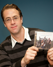 Jose Curbelo holds up his CD 