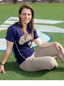 Julie Orlandi sits of field with Colonials jersey on