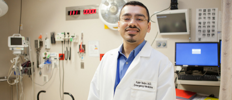 Kabir Yadav in lab coat in medical room