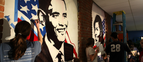 students working to paint murals of President Obama and Michelle Obama 