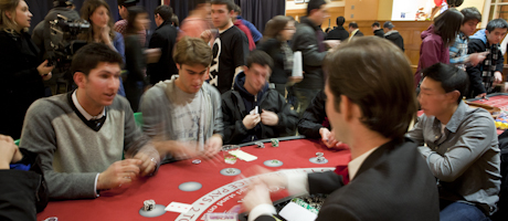 group of male students play blackjack seated at casino table at Martha's Marathon