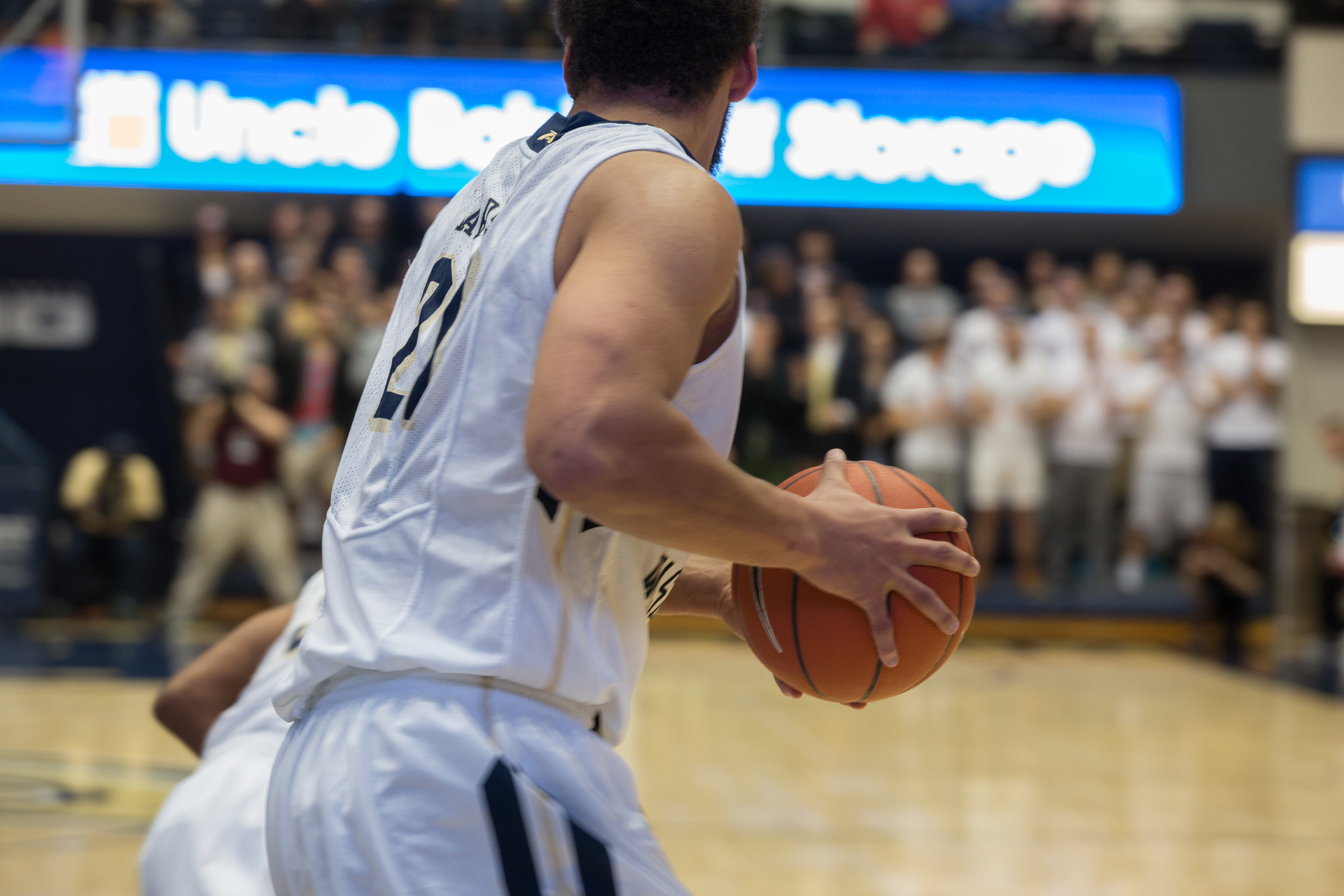 male basketball player on court holding ball