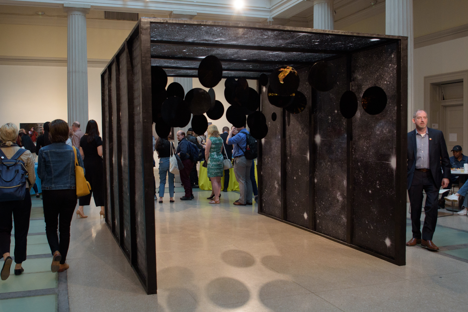 participants walk under art installation at NEXT 