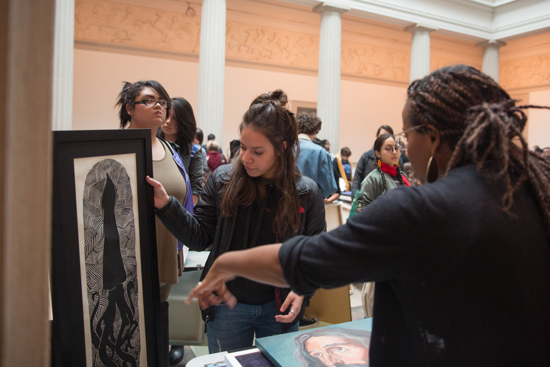 A student receives a critique of her work from a university representative at National Portfolio Day. (William Atkins/GW Today)