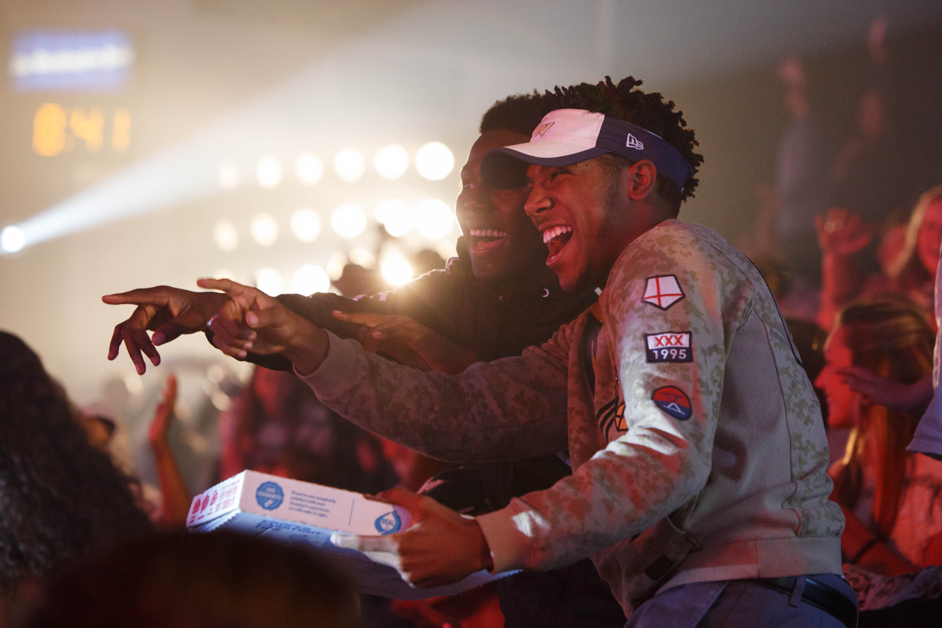 students laughing and pointing at Colonial Madness