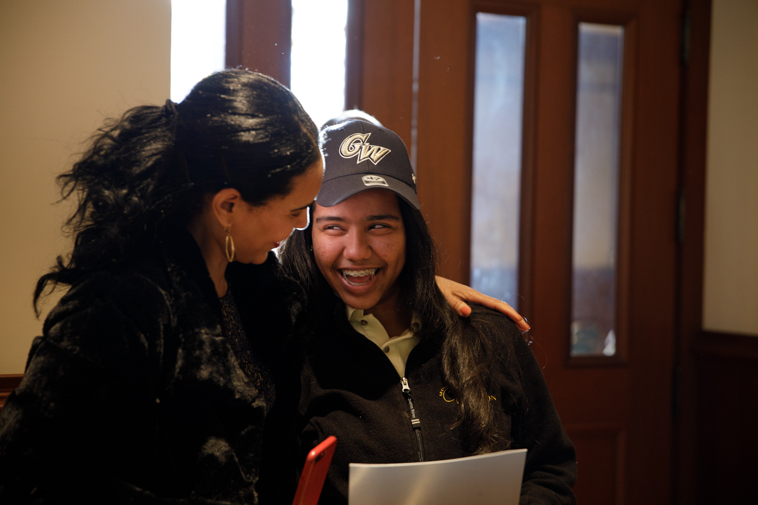 smiling SJT award winner embraced by woman