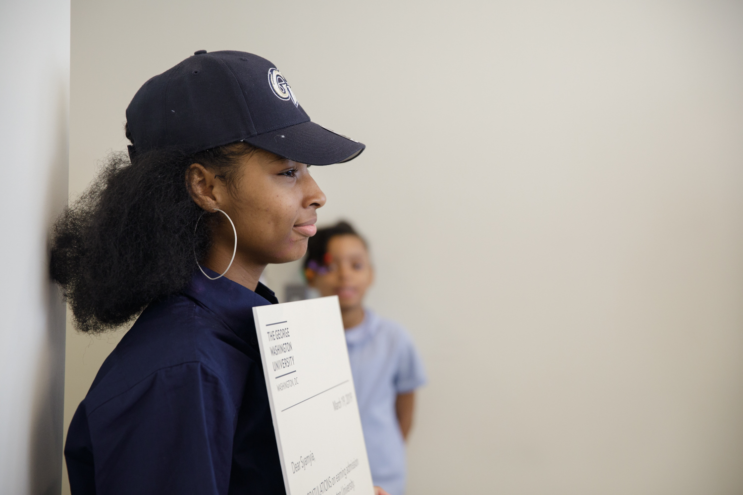 SJT winner holds up scholarship award letter smiling