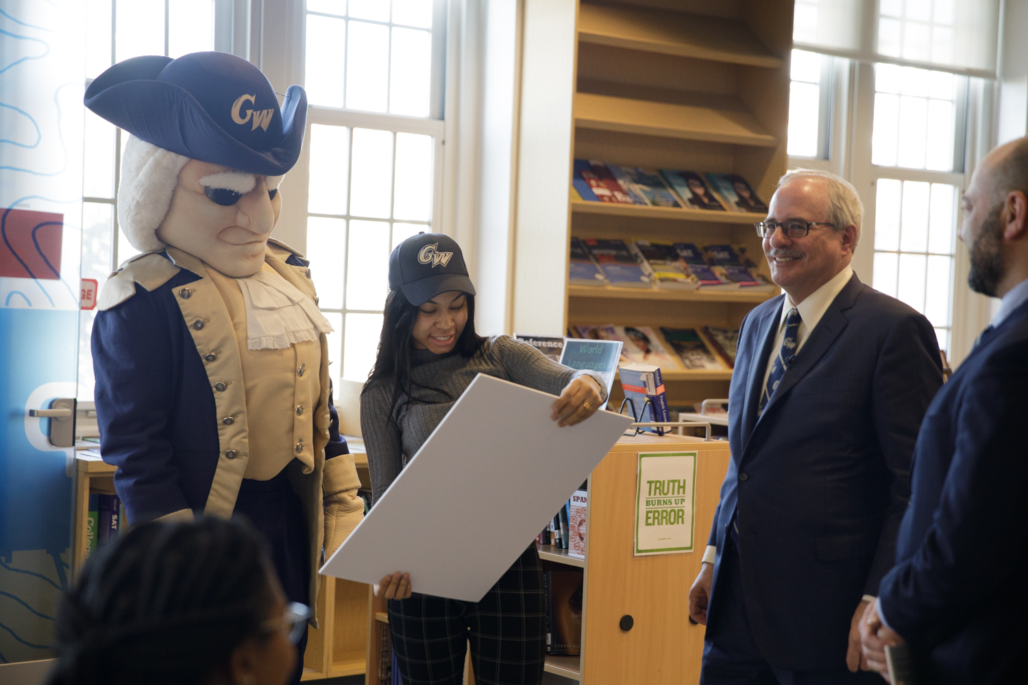 SJT recipient smiles  with mascot George and Dr LeBlanc looking on
