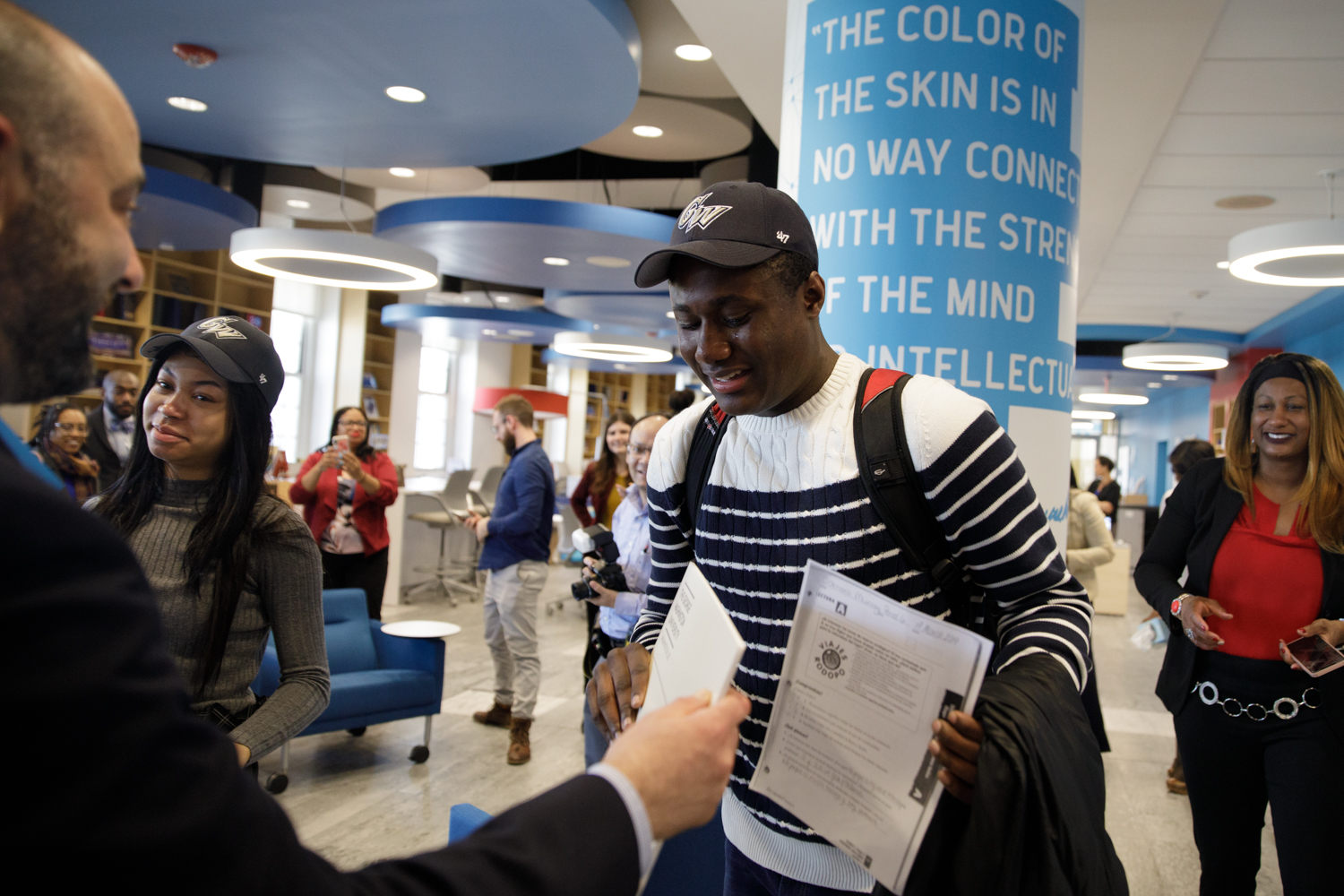 smiling SJT recipient wearing a GW hat