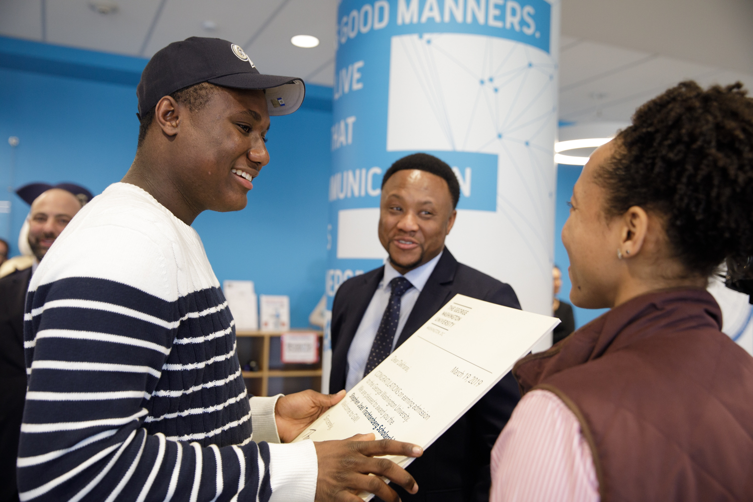smiling SJT recipient wearing a GW hat