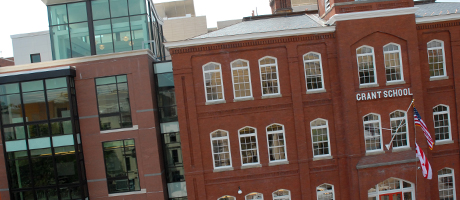 exterior of the brick facade of the School Without Walls with Grant School sign