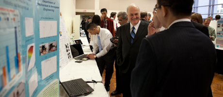 university community observes research presentation boards at Research and Development Showcase 