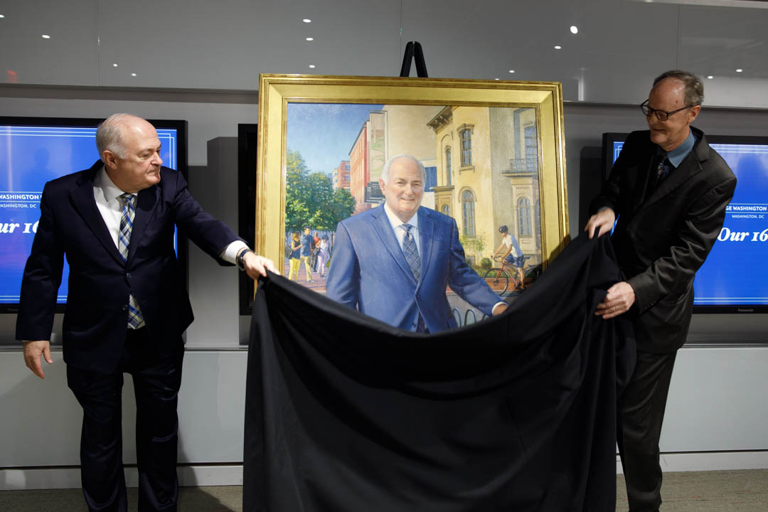 Steven Knapp and portraitist Bradley Stevens unveil Mr. Stevens' painting at the National Churchill Library and Center. (William