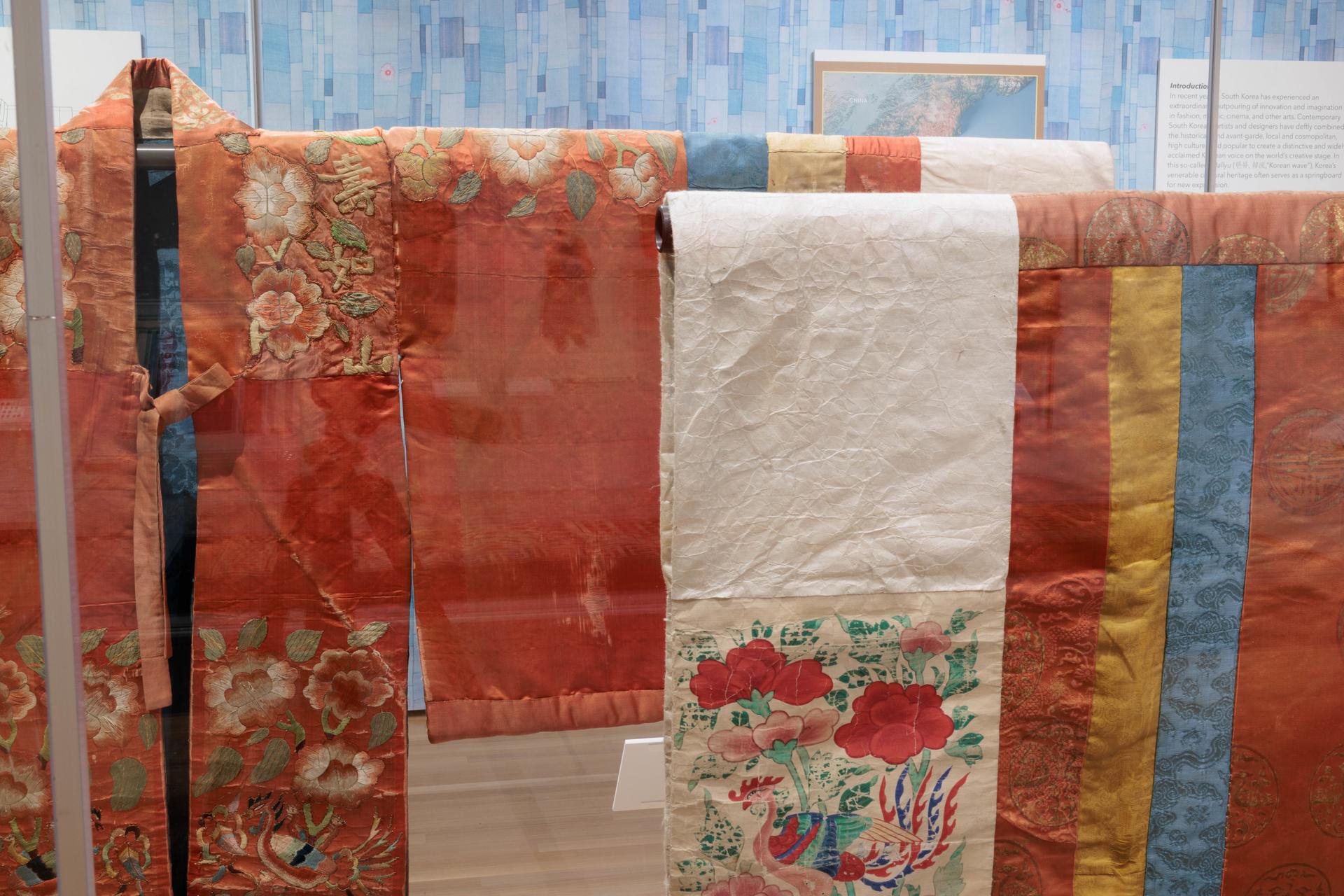 Joseon wedding robes on display in "From Royal Court to Runway" feature ornate embroidery and patchwork techniques. (William Atk