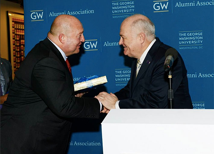 GW President Steven Knapp shakes hands with Mustafa Koç, chairman of the board of Koç Holding, at Thursday night's alumni event.