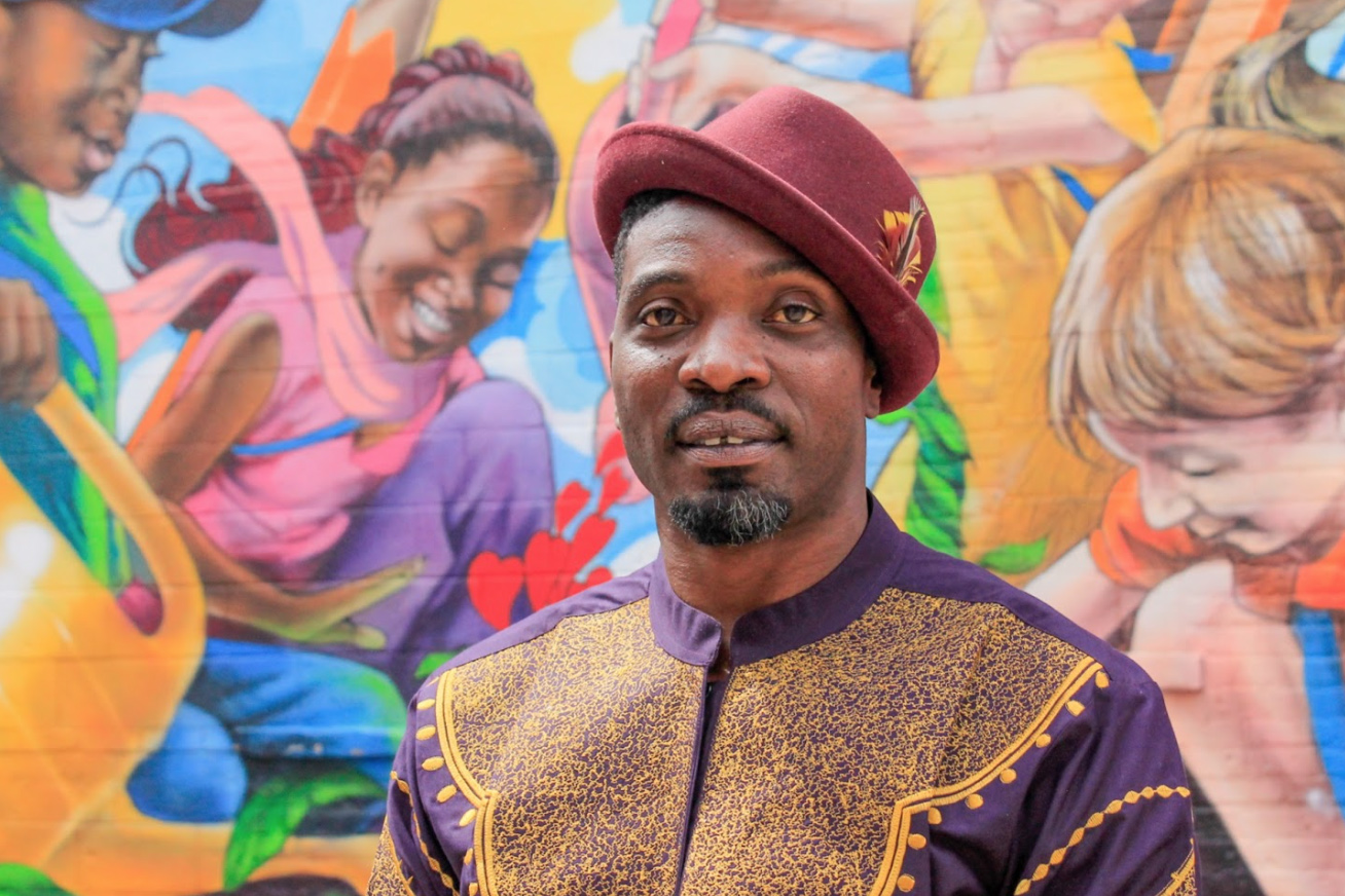 This photo of Aniekan Udofia in front of one of his many murals is part of the FourStoried project. (Photo by Ayah Mahana for Fo