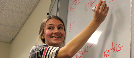Female student writing on write board