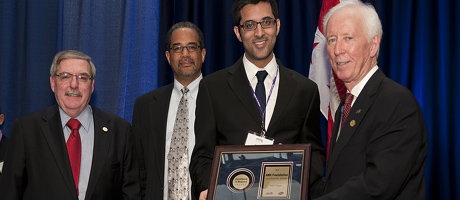 Rahul Vanjani receives award at AMA event and stands with AMA members