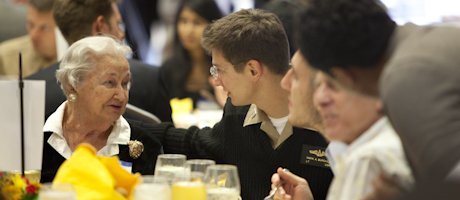 students and veterans sit at table at veterans lunch