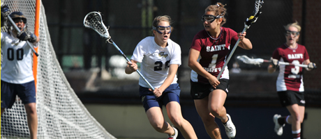 GW Lax player Caitlyn O'Brien plays against players from Saint Mary's 