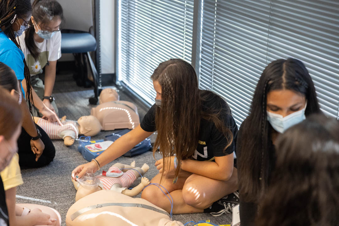 Students practice life-saving techniques during CPR training held during GW Days of Service.