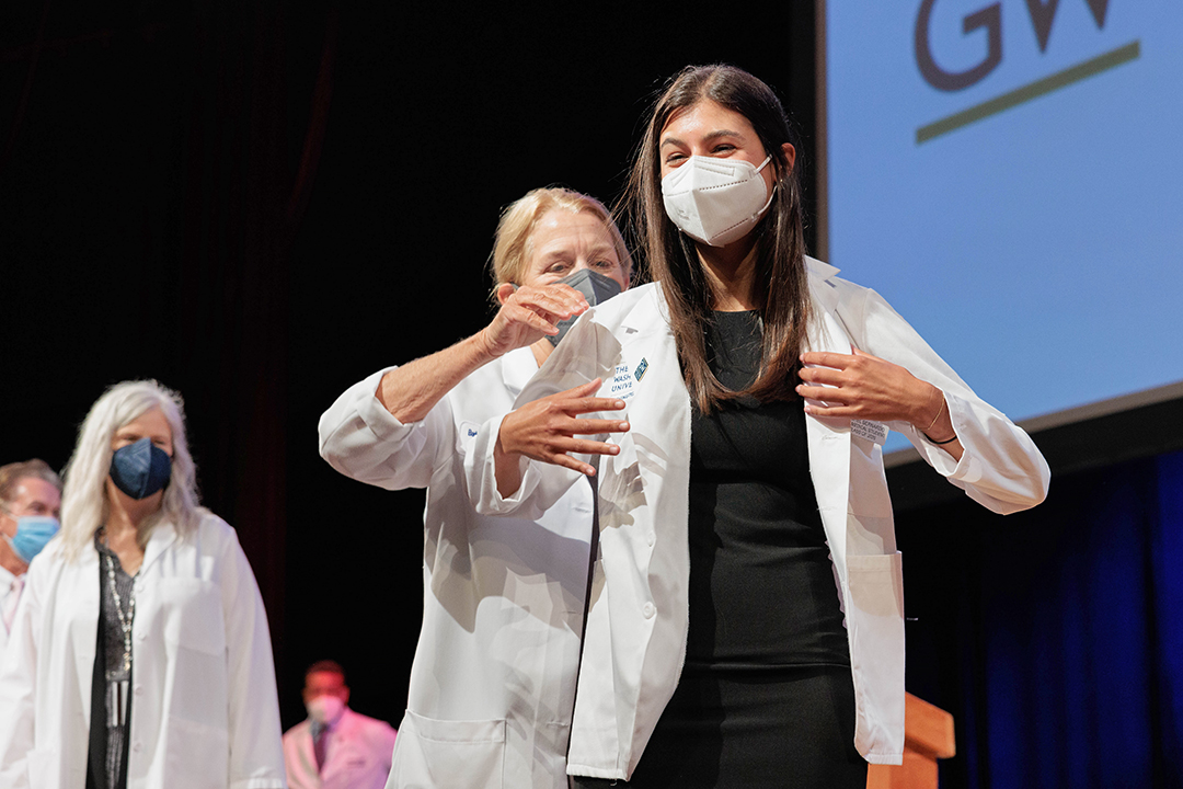 Student receiving white coat