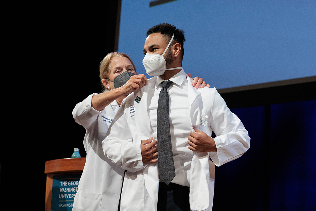 Student receiving white coat