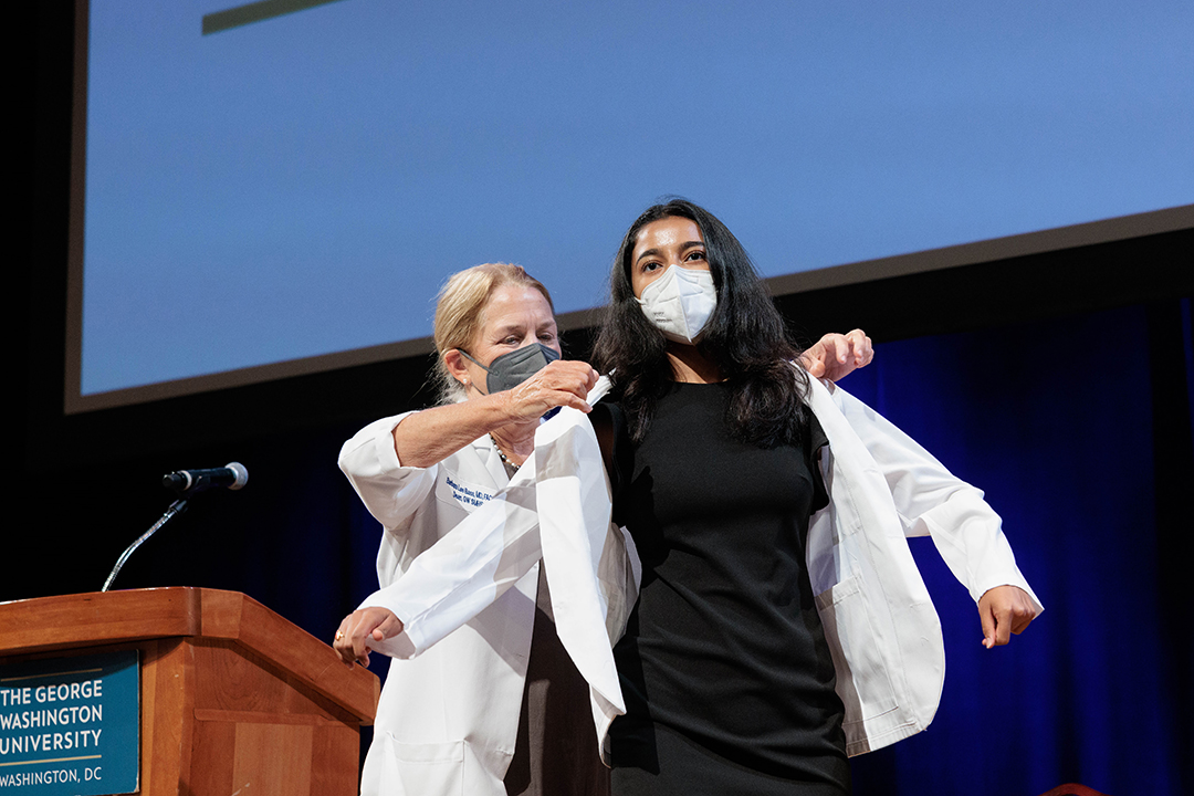 student receives white coat