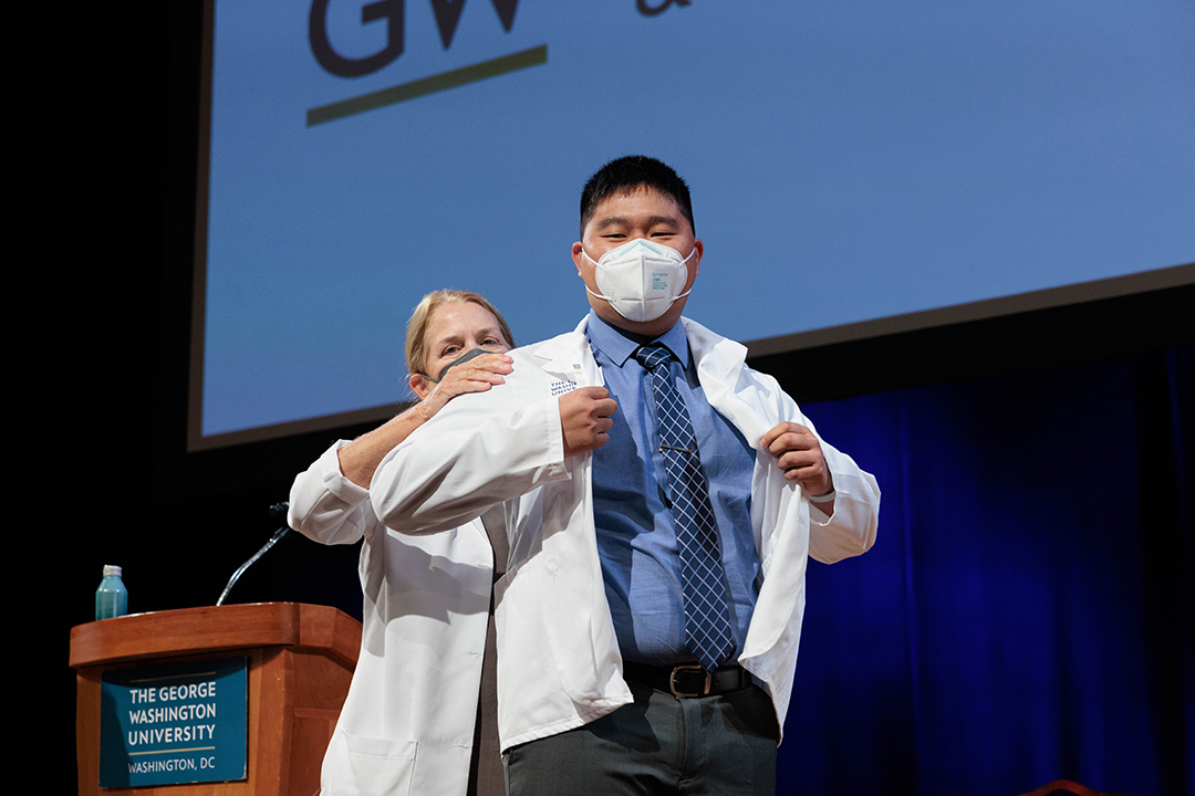 student receives white coat