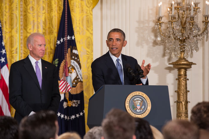 President Obama at Presidential podium joined by Joe Biden