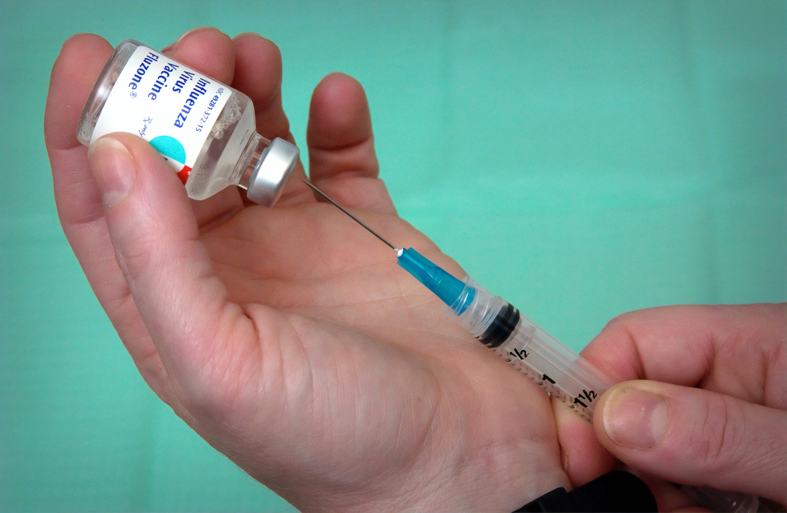 Photo of a syringe drawing flu vaccine