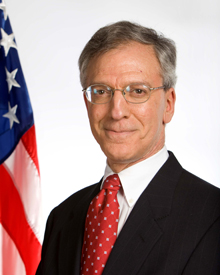 Gordon Daniel with American flag behind him