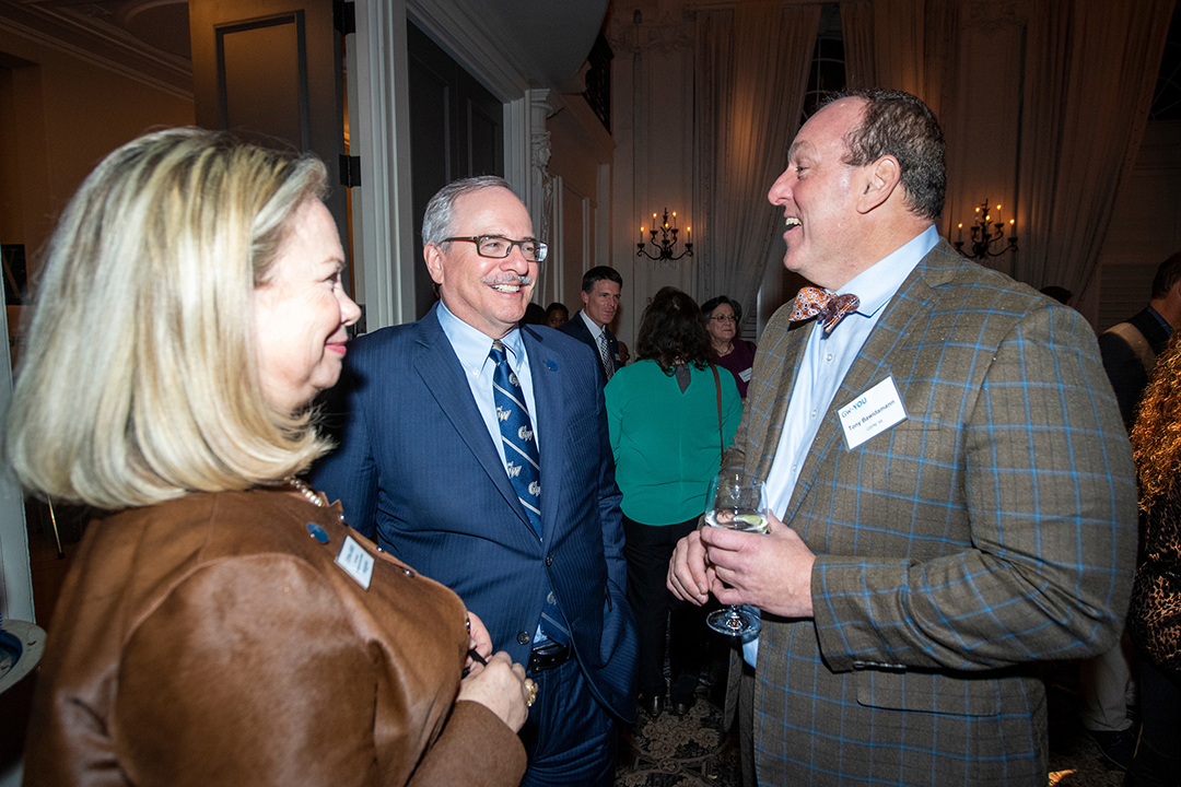  Donna Arbide and President LeBlanc talk with Tony Bawidamann, M.A. ‘96 during the cocktail hour at GW + You Philadelphia.