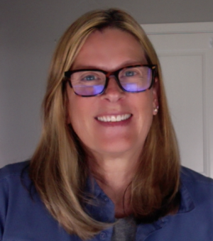 Professor of Geography Lisa Benton-Short in a blue shirt, wearing black glasses.