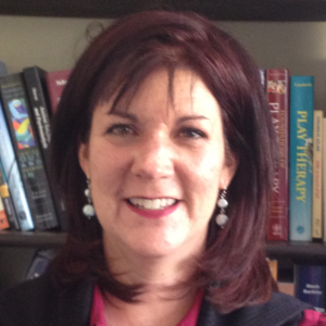 , Karen L. Weise, chair of the Child and Adolescent Track at the Columbian College of Arts and Sciences’ Professional Psychology Program, with brown hair and a bookshelf behind her.
