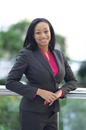 Assistant Professor of Clinical Psychology Katherine Marshall Woods in a dark suite and red shirt 