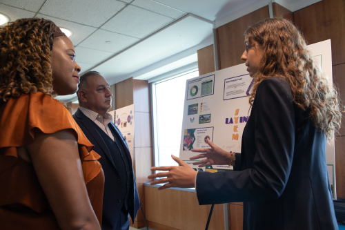 CAPTION: Carmen Colón, a high school senior from New Orleans, presented her final project to Cisneros and Chante Clarkson, executive director of academic success programs at the Office for Student Success.