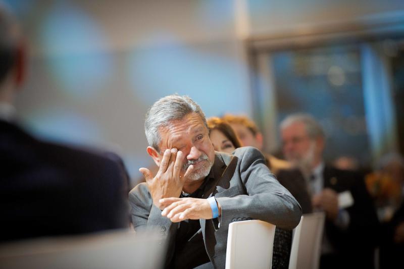 Emotional man at table in audience