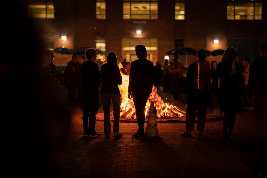 Students standing around bonfire