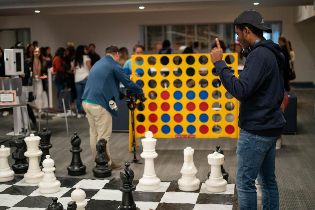 Students playing large chess and connect 4